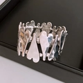 Detail of silver heart stretch bracelet featuring textured hammered metal surface - Silver
