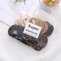 Detail of high elasticity hair ties in earth tones with stylish card packaging - 50 Pcs Bag / Milk Tea Colors
