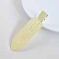 Close-up of yellow acetate hair clip with UANODIAM engraving on metal duckbill clamp - 18# Metal 7cm Yellow No-Trace Clip
