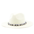 Close-up of Panama straw hat featuring seashell and wooden bead trim on navy band - Cream