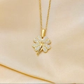 Elegant gold four-leaf clover pendant necklace with paved crystals on champagne silk background - Gold