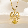 Detail of gold bow necklace with yellow orb pendant on soft silk texture background - Yellow Planet Orb Bowknot (F211)