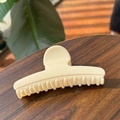 Creamy beige claw clip on a wooden table with green leaves in soft sunlight - 11.5CM / Cream White