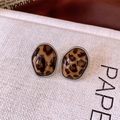 Close-up of leopard print acrylic oval stud earrings with silver twisted metal borders - Silver Brown Irregular Leopard Print (WE4209)
