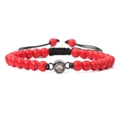 Handmade woven bracelet featuring red natural stone beads and a black circular charm pendant - Red Turquoise