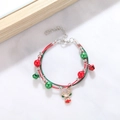 Detail of Christmas bracelet with bells and golden reindeer pendant on white marble - Style E Reindeer