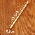 Detailed close-up of a vintage bamboo-shaped brass pen on a textured wooden surface - Bamboo Pen (Da Zhan Hong Tu) / Gold