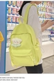 Detail view of a neon yellow nylon backpack featuring a cute white plush bear keychain - With Pendant / Green
