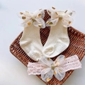 Close-up of baby socks and headband set with tulle bows in a decorative tray - Off-white Polka Dot Bow Set
