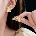 Detailed view of golden flower earrings with brushed metal petals and a center pearl - Gold Brushed Flower Pearl Earrings (17#)