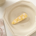 Macro detail of yellow acrylic hair clip with white daisy floral pattern on a plate - Yellow with Small White Flowers