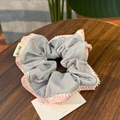 Detailed view of grey hair scrunchie with pink bows and delicate white lace trim - Blue Bow Pink Blue Contrast