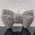 Macro shot of colorful rhinestone bow clutch bag with shimmering rainbow crystal details - Silver AB
