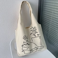 Minimalist cream canvas tote bag with black cat line art illustration on white chair - Cat with Flowers