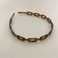 Macro view of tortoiseshell chain headband with resin link texture and vintage design - Tortoiseshell Brown