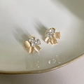 Macro detail of six-petal flower earrings with pink cat eye stones and clear diamonds - 18k Gold Floral Style