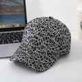 Close-up of black and white leopard jacquard baseball cap with woven floral patterns - One Size / Dark Gray