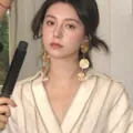 Elegant gold-tone multi-disc fringe drop earrings worn by a model in casual attire - Retro Textured Four-layer Round Discs (1#)