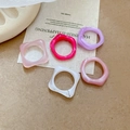 Close-up of five acrylic resin rings featuring colorful marble texture and jelly gloss - White-Pink Set (Five Pieces)