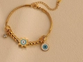 Detail of gold snake chain bracelet with evil eye pendants and sparkling rhinestone - S084 Gold Sunflower Evil Eye Bracelet