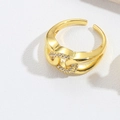 Detailed macro shot of French retro crisscross ring with pavé micro-diamonds and gold finish - Double Layer Cross Buckle / Gold