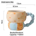 Tazza in ceramica dipinta a mano con fiocco arancione e manico a perline blu - Perline Fiocco