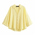 Detailed view of loose fit V-neck linen shirt with button-down front and curved hem - Yellow