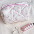White quilted cosmetic bag with pink bows and zipper for travel storage - Pink Hollow Bow