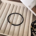 Detail of black elastic hair band with gold metal bead on beige linen tray - Black (With Gold Metal Clasp)