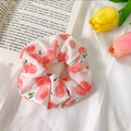 Pink scrunchie with peach pattern and green leaves on white fabric background - Pink Peach