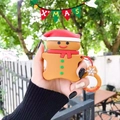 Gingerbread man silicone AirPods case with festive ring holder in a holiday setting - Gingerbread Man