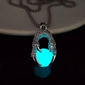 Close-up of luminous blue orb held by a dragon claw pendant on a stainless steel chain - Teal