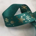 Close-up of green ribbed Christmas ribbon with gold snowflake and star foil patterns - 2.5cm Snowflake Green / 22 Meters