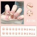 French cream puff press-on nail kit with 24 pink tips featuring red wavy lines and stars - Glue Style (A3136)