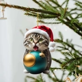 Close-up of a tabby cat ornament with a red Christmas hat holding a teal festive bauble - Cat 4