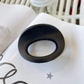 Detail shot of a matte black oval claw clip on a magazine for hair styling - Approx 7cm / Matte Black