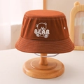 Detail view of caramel cotton canvas bucket hat with bear embroidery and windproof strap - 54cm 3-8 Years Old / Brown