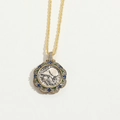 Detailed macro of gold twisted chain necklace with coin pendant and colorful gemstone insets - Blue Zircon Coin