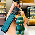 Dark green cartoon bear keychain with leather strap and yellow bow tie detail - Green