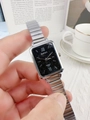 Close-up of silver square watch with black star dial and roman numerals on metal band - Silver Black Dial