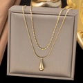 Detail view of double-layer gold titanium steel necklace with water drop pendant - Double Layer Long Water Drop / Gold