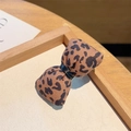 Stylish brown leopard print hair clip with black ribbon knot for a chic fashion look - Small Leopard Bow Clip