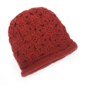Close-up of handmade red crochet knit hat featuring 3D floral patterns and ribbed edge - One Size / Burgundy