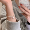 Elegant pearl bracelet featuring silver beads and a star charm on a female wrist - S477 Silver