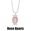 Detail view of pink rose quartz gemstone inlaid in a vintage silver owl pendant necklace - Rose Quartz
