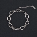 Detail of silver chain bracelet showing oval links, lobster clasp, and extension chain - Oval Ball Design (Style 1) / Silver