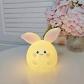 Cute bunny silicone night light with warm yellow glow and soft blue eye details - Pipi Rabbit