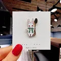 Close-up of a cute rabbit enamel pin with green bow and spoon accessory detail - 43*Rabbit with Spoon Pin