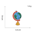 Detail view of globe embroidery patch with dimensions 7.9 cm x 4.4 cm on white background - Globe