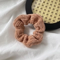 Detail of reddish-brown corduroy scrunchie showing soft ribbed texture on a white background - Corduroy / Orange